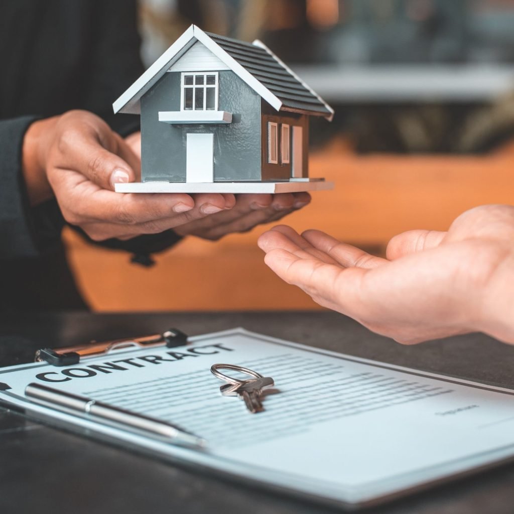 Thumbnail image featuring a professional workspace with a contract, financial documents, and keys, representing selling a property management business.