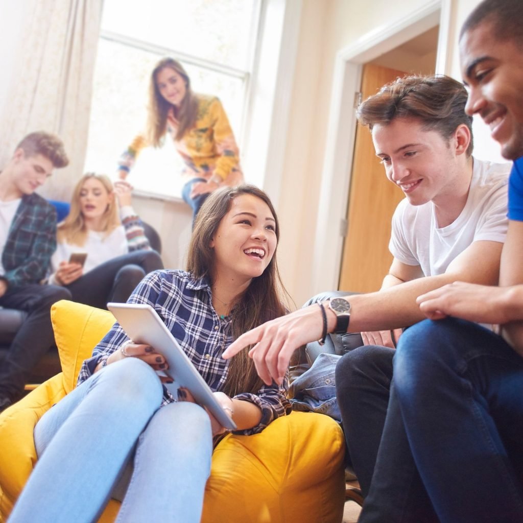 A modern student housing building with students in it.