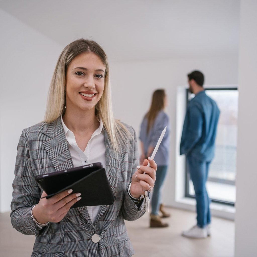 Real estate agent explaining property documents to clients in a professional setting.